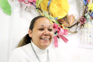 New Support Worker smiling among soft backdrop