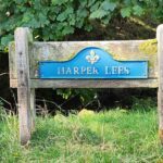 A sign that reads "Harper Lees," designed for easy readability in a public space.