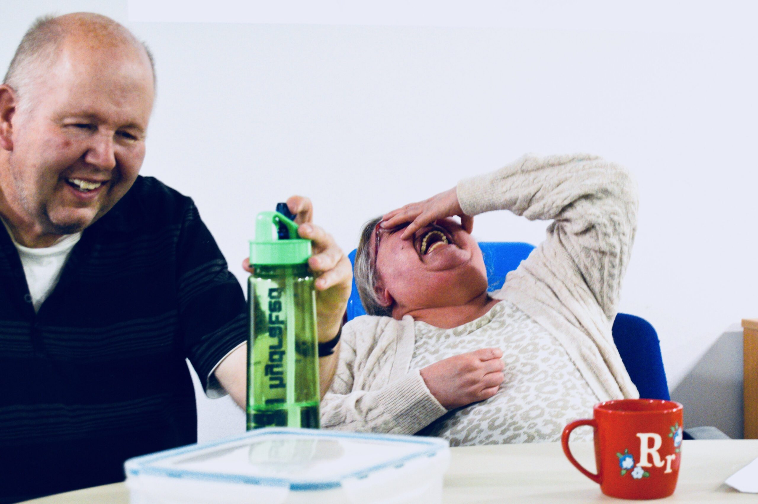 Two adults with learning disabilities having a relaxing time and laughing