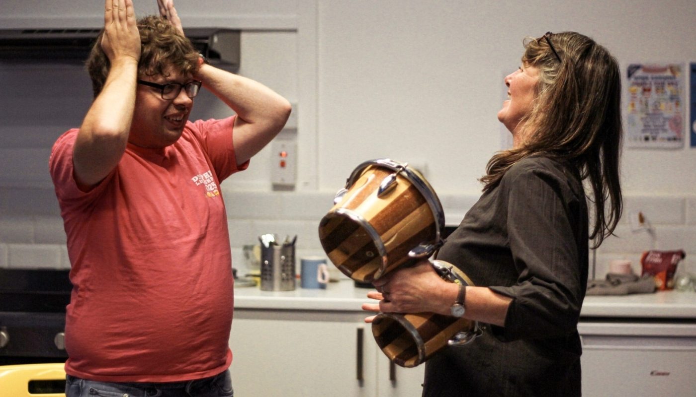 Two support workers for disabled people prepare for a creative session