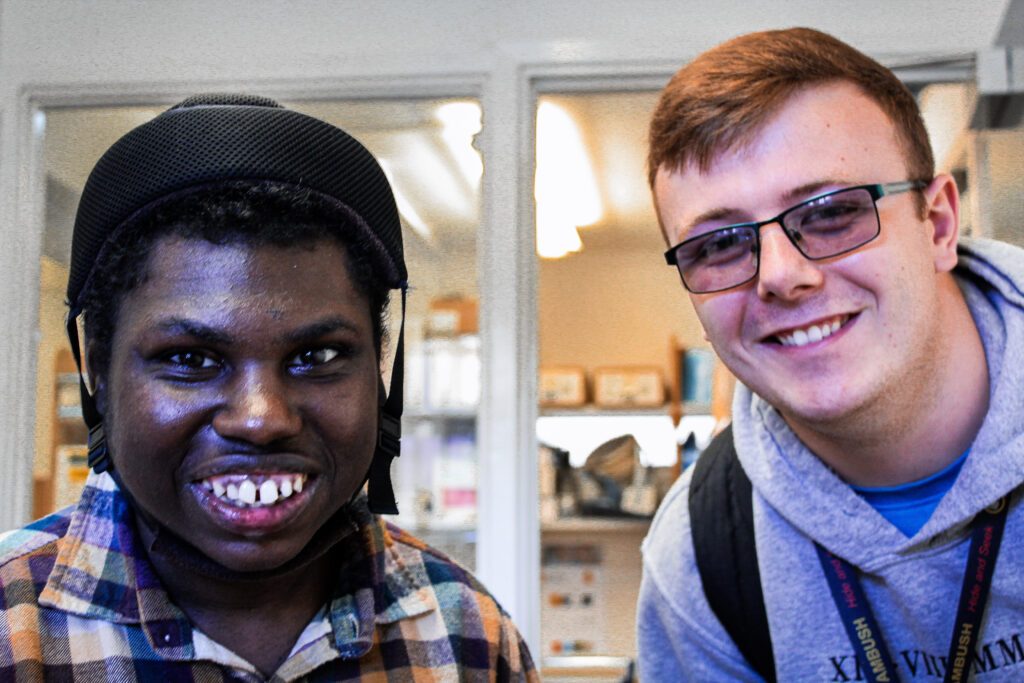 New client with a learning disability smiling with his Support Worker