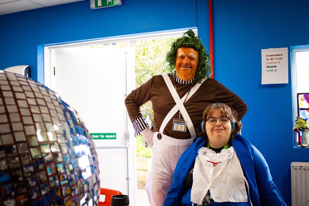 A disabled client and her support worker enjoying Roald Dahl Day by dressing up as famous Quentin Blake characters