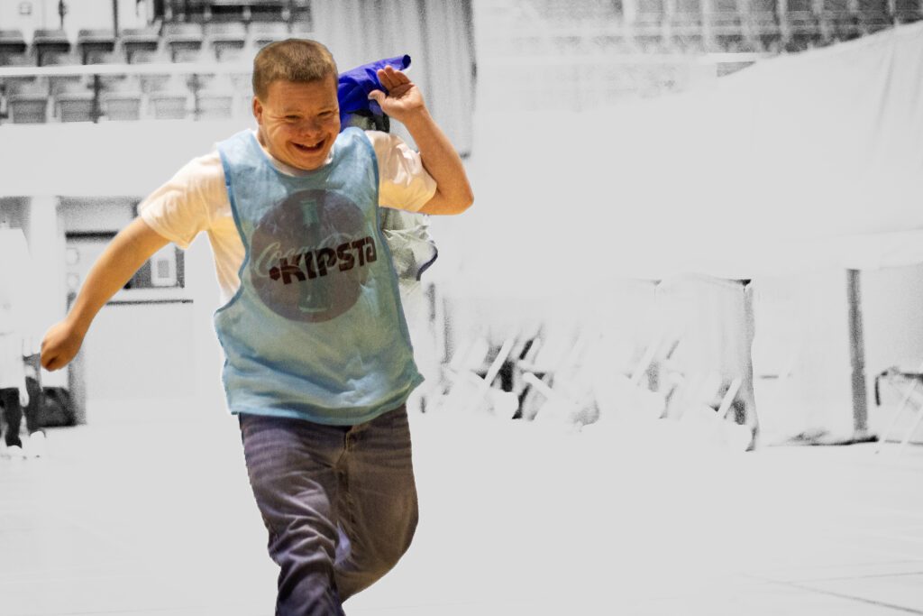 Client with learning disabilities running and being happy in disability sports day Sheffield