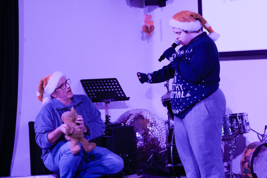 Person with learning disability on stage singing in Sheffield