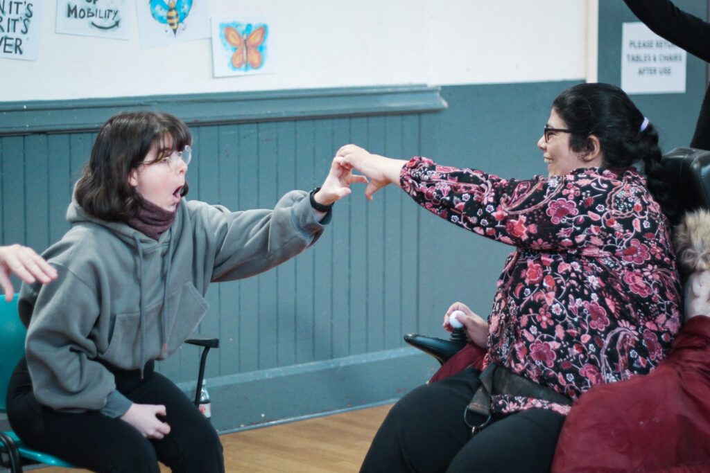 Adult with learning disability in Sheffield shaking hands with support worker