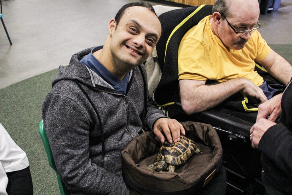 Man with learning disability pets tortoise in Sheffield charity