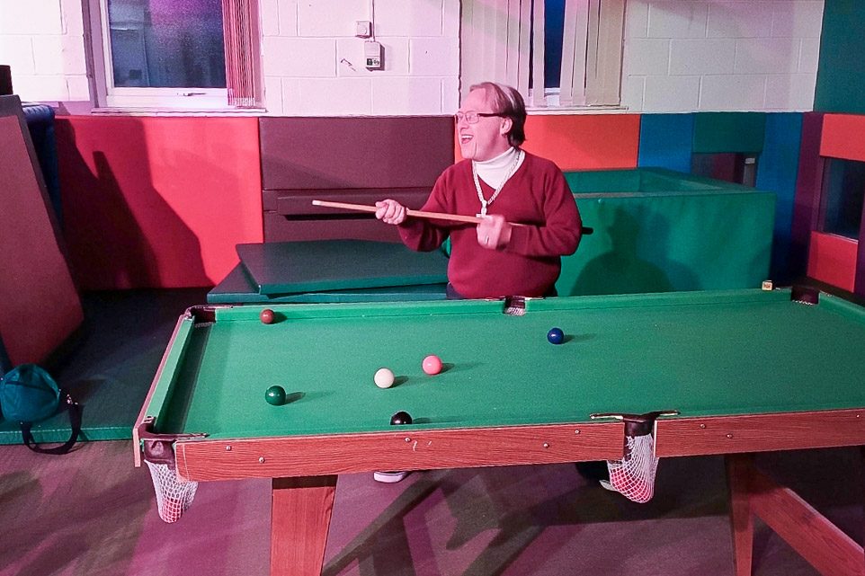 Man with learning disability playing snooker and having fun at Burton Street Foundation in Sheffield