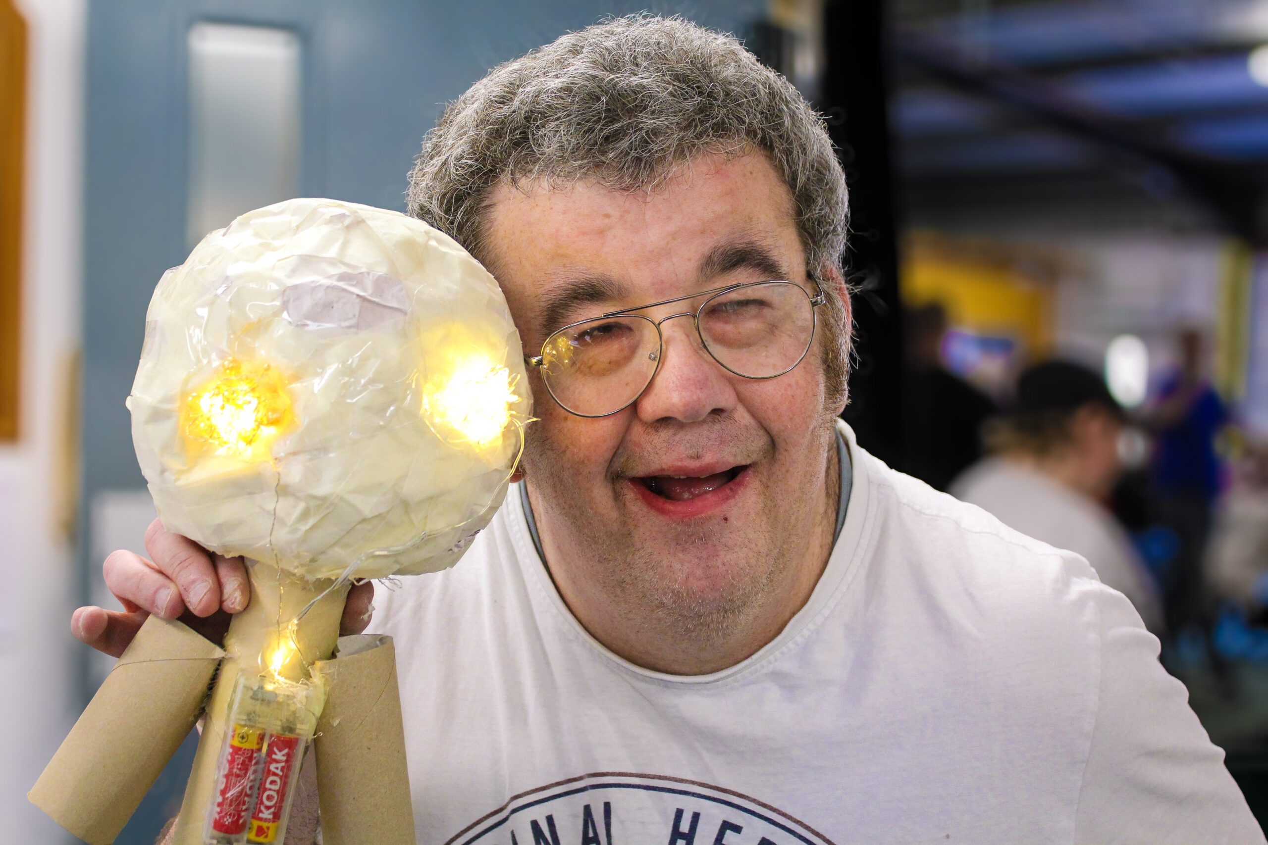 Man with learning disability showing off arts and crafts puppet at Burton Street Foundation in Sheffield