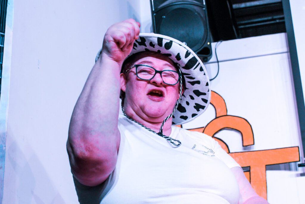 Woman with learning disability performing at a talent show at Burton Street Foundation in Sheffield