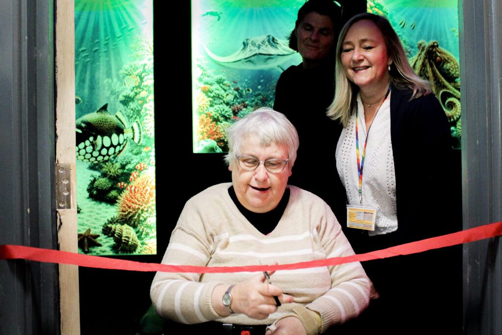 Client opening our new sensory room by cutting the ribbon